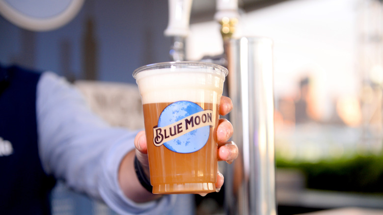 Blue Moon beer poured into a cup.