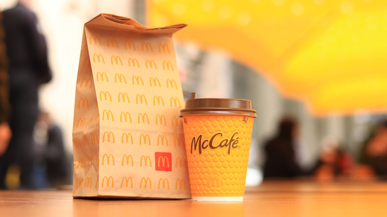 McDonald's bag next to a coffee