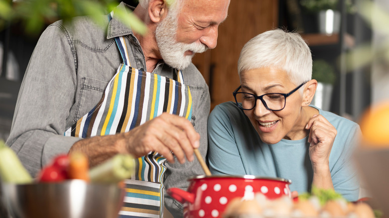 A senior couple preparing breakfast.