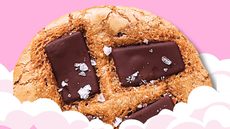 Nowhere Bakery's chocolate chip cookie on pink background with clouds