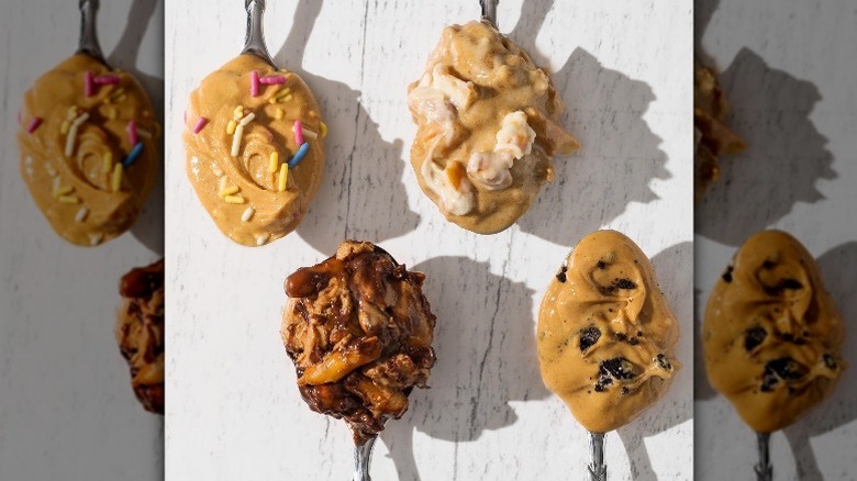 Four flavors of nuts n more peanut butter on spoons