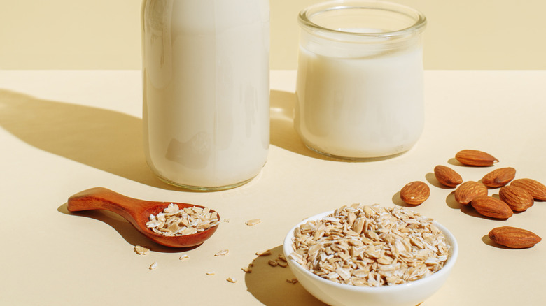 Almonds and oats on beige background