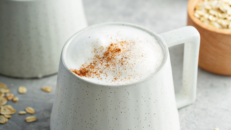 Latte sprinkled with cinnamon in white mug