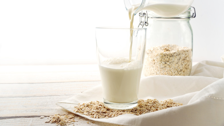Oat milk being poured into a glass