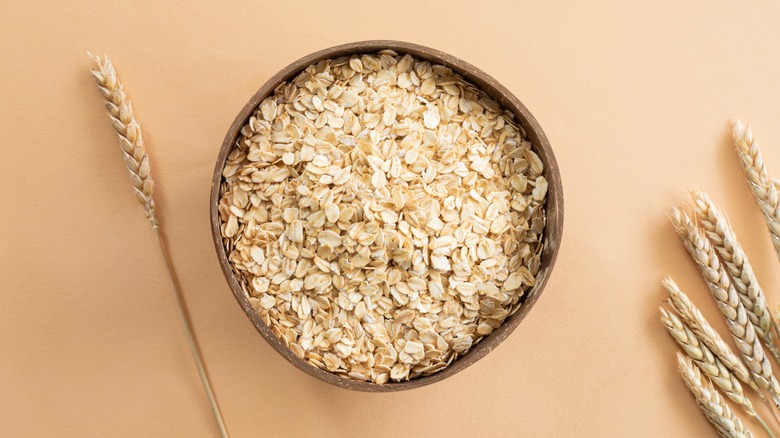Oats in a bowl on beige background