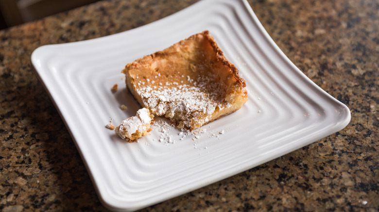 a small slice of gooey butter cake with a bite missing