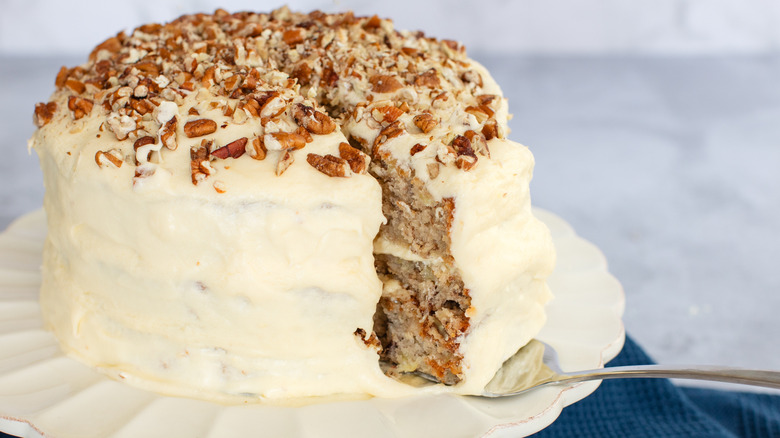 hummingbird cake on a plate with a slice taken out