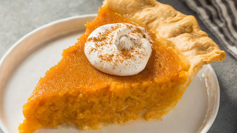 sweet potato pie with a dollop of whipped cream on top