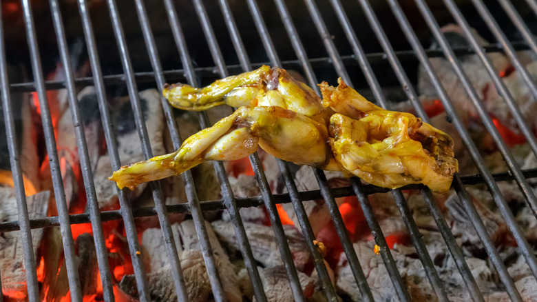 Frog legs on a barbecue grill