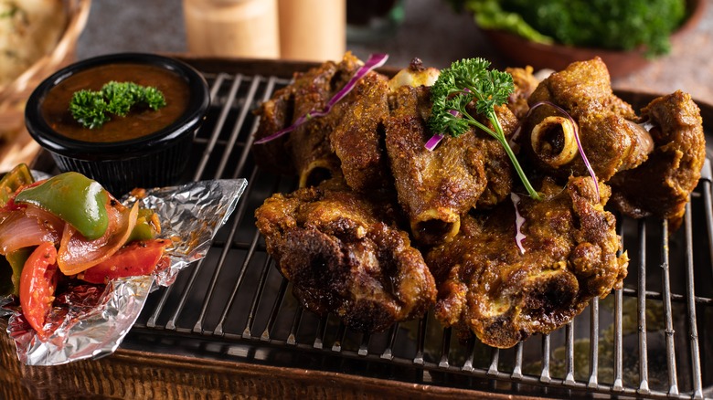 Barbecued mutton joints on a grill