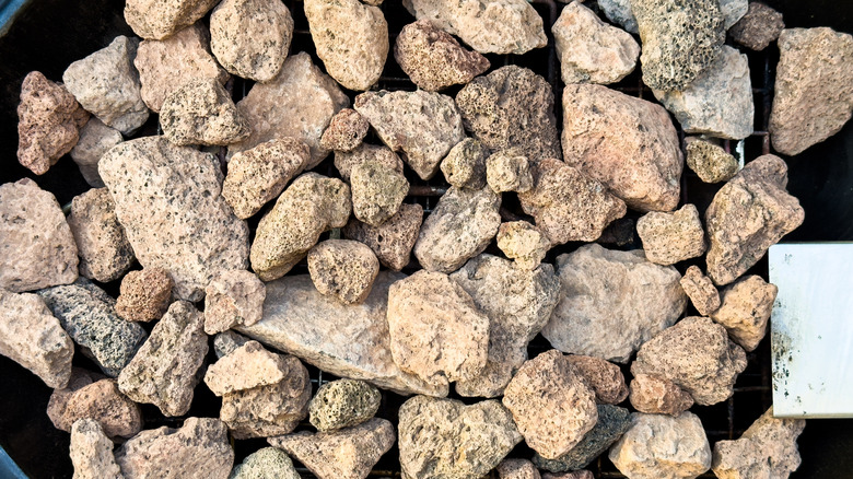 Lava rocks in a round grill ready to be used