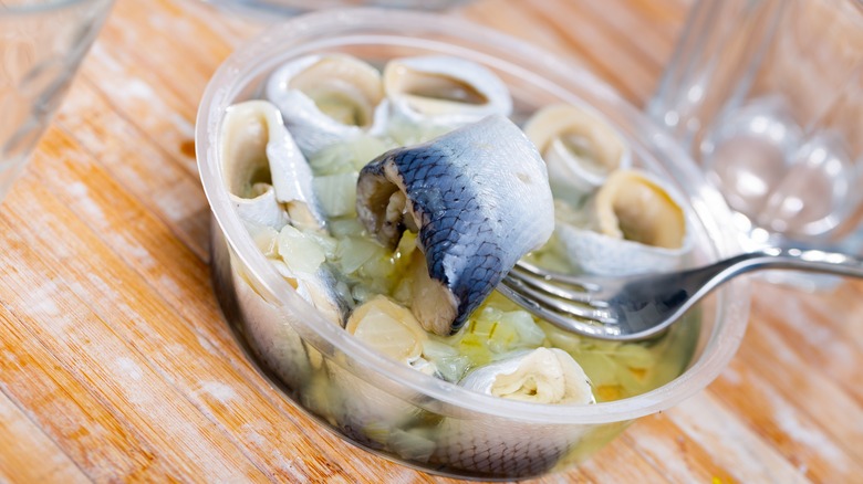 Prepared herring in a deli container