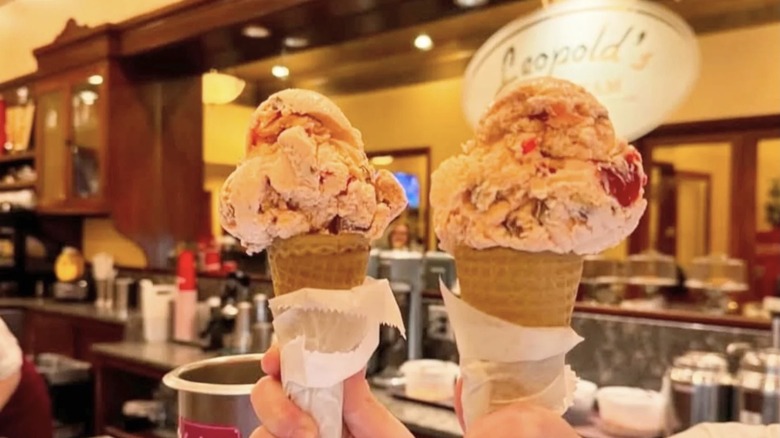 Two waffle cones piled high with tutti frutti ice cream