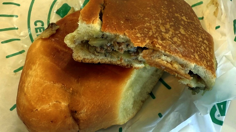 Runza split open revealing beef, cabbage, and onions