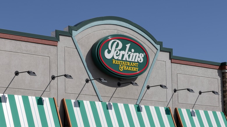 Perkins restaurant exterior signage of green and white striped awnings