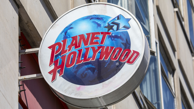 Circular Planet Hollywood sign jutting out from a building