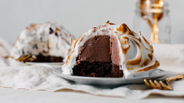 Baked Alaska with slice cut out to reveal layered inside