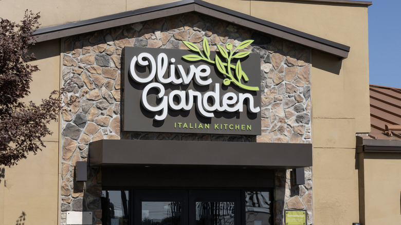 Olive Garden sign hanging on restaurant