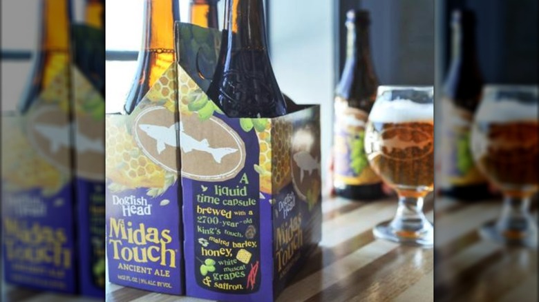 A pack of Midas Touch bottles and a glass of the beer
