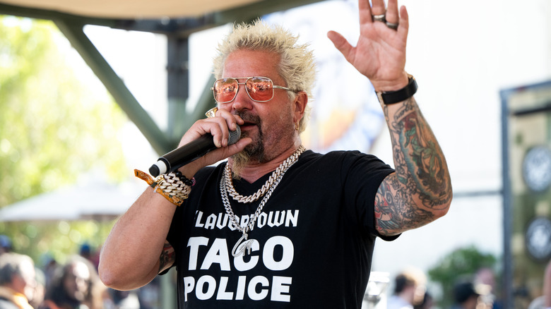 Guy Fieri speaking into mic