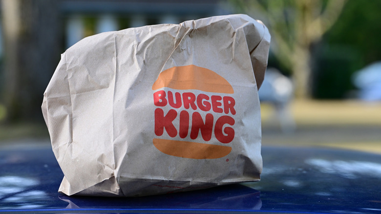 A Burger King bag full of food.