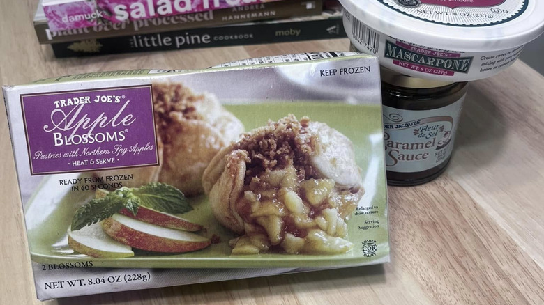 A box of Trader Joe's Apple Blossoms sits on a table with a jar of caramel sauce and some mascarpone cheese