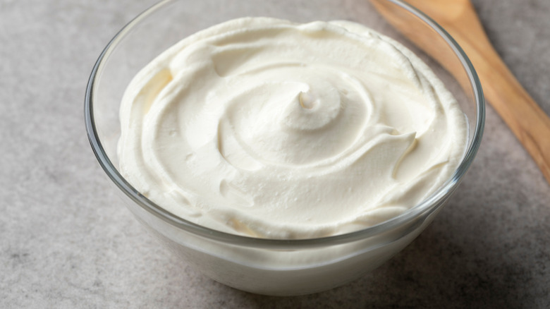 Crème fraîche in a glass bowl with spoon