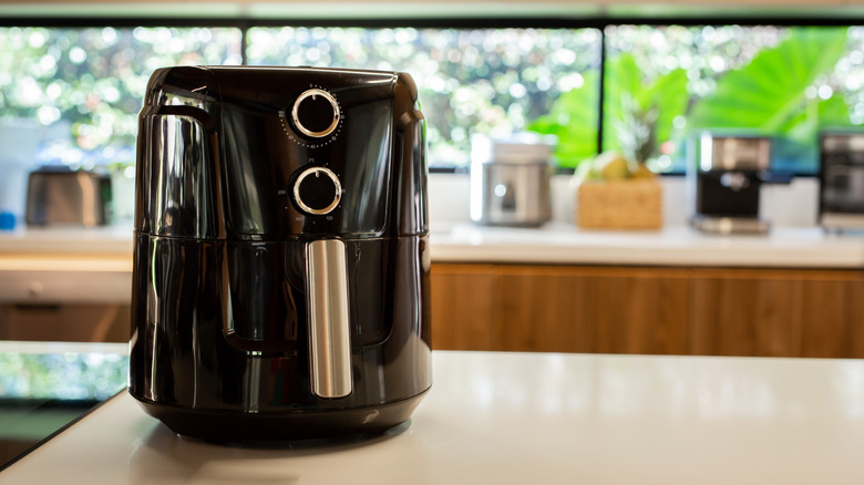 A Black air fryer on a kitchen counter