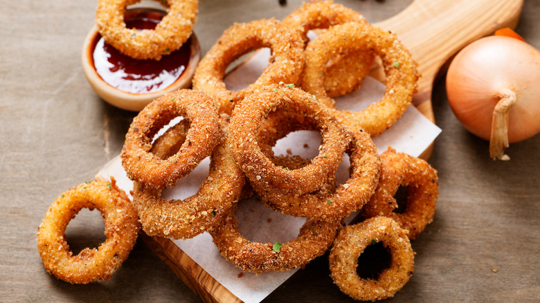Homemade onion rings on board