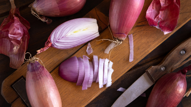 cutting shallots on a cutting board