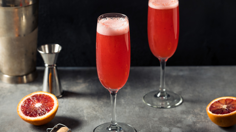 pink mimosas with grapefruit halves next to them