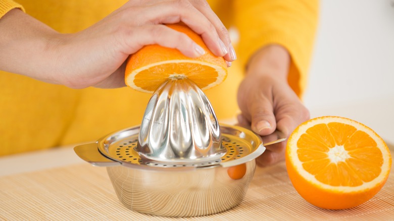 squeezing the juice from an orange