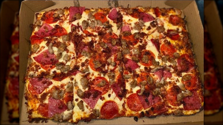 A pizza from Price Chopper sits in a cardboard box.