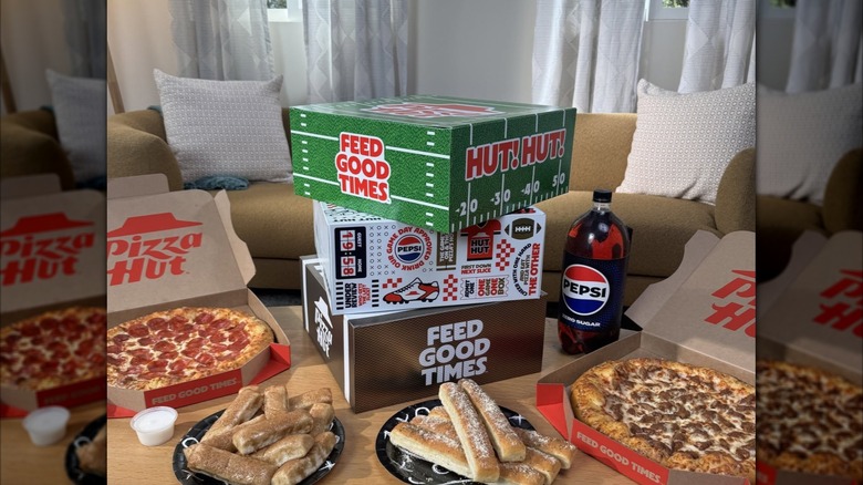 A game-day selection of food from Pizza Hut sits on a table.