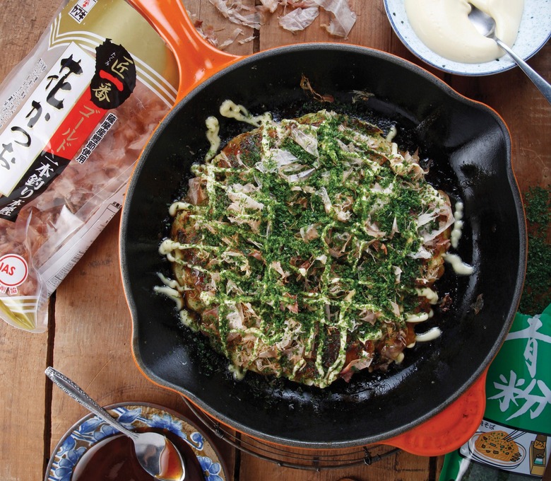 Okonomiyaki is a Japanese pancake prepared with octopus, squid, chicken, scallions or kimchi