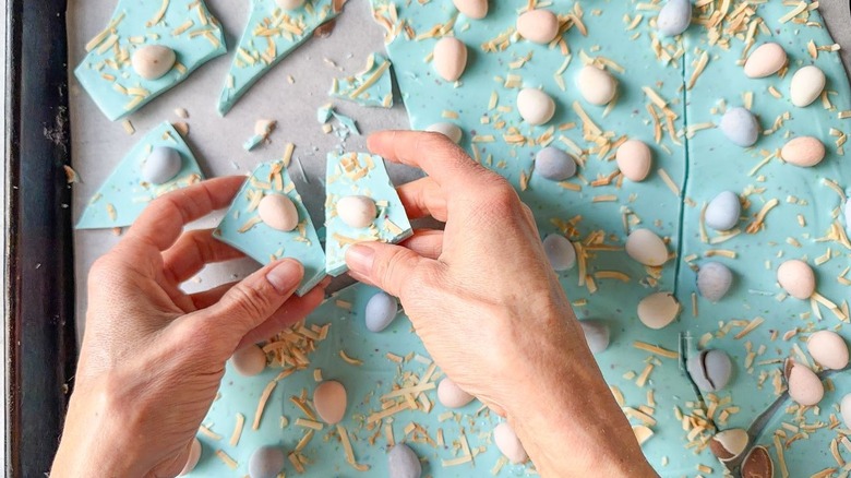 Breaking pastel blue 3-ingredient Easter bark into pieces