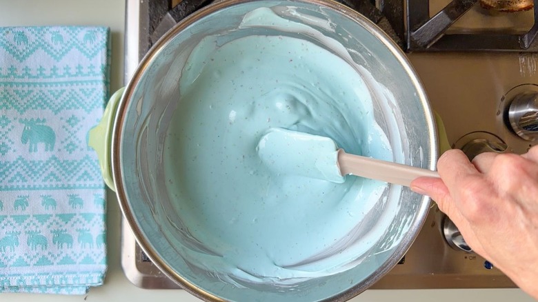 Melted pastel blue candy melts in double boiler