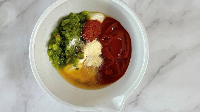 Relish, ketchup, mayonnaise, and seasonings in bowl