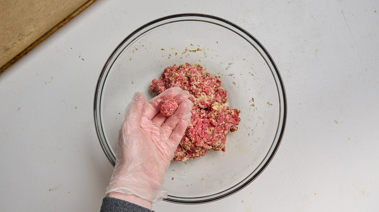 rolling meat into meatballs