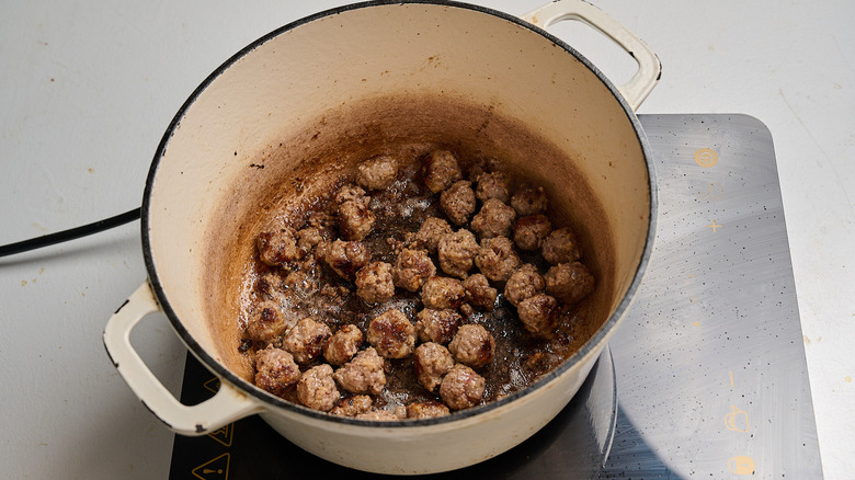 searing meatballs in a pot