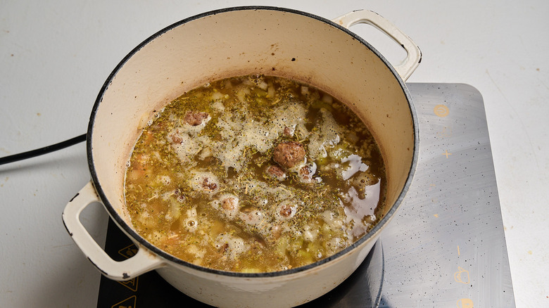 broth and seasonings added to a pot