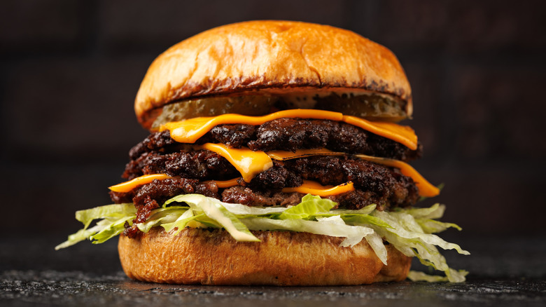Triple patty smashburger with cheddar cheese and lettuce