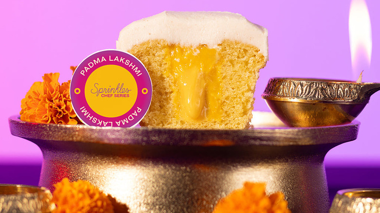 Sprinkles Luscious Mango cupcake on pedestal 