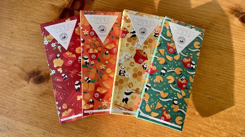 All four flavors of Panda Express x Compartés Chocolate Bars fanned out on wooden table