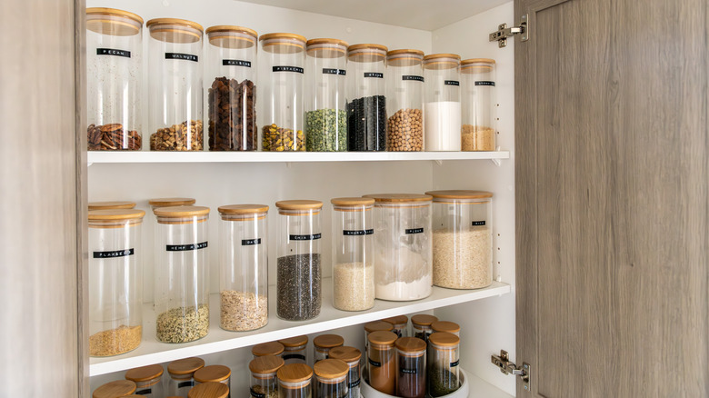 A well organized pantry with labelled glass jars