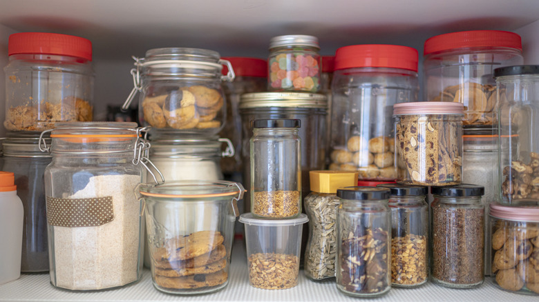 A pantry that's been organized with repurposed jars