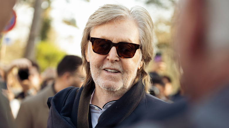 Smiling Paul McCartney wearing sunglasses