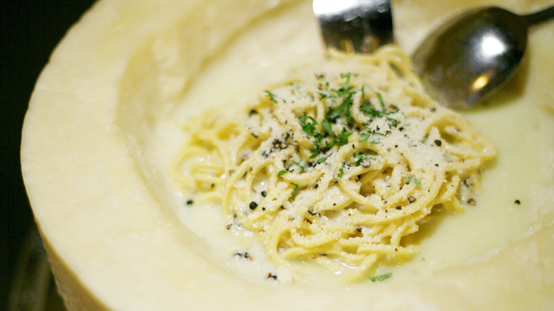 Cacio e pepe made in wheel of pecorino romano cheese