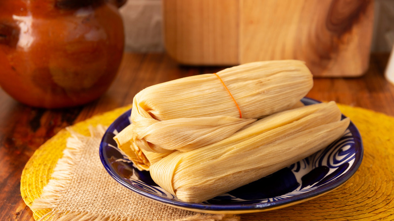 Several tamales on a plate.