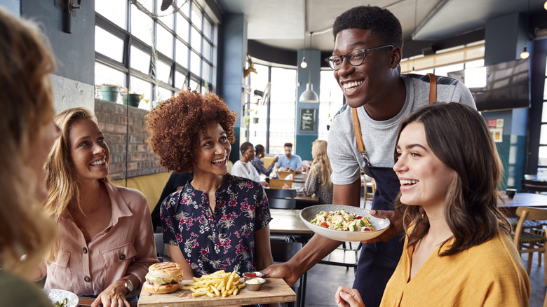 Friendly interaction between diners and a server.